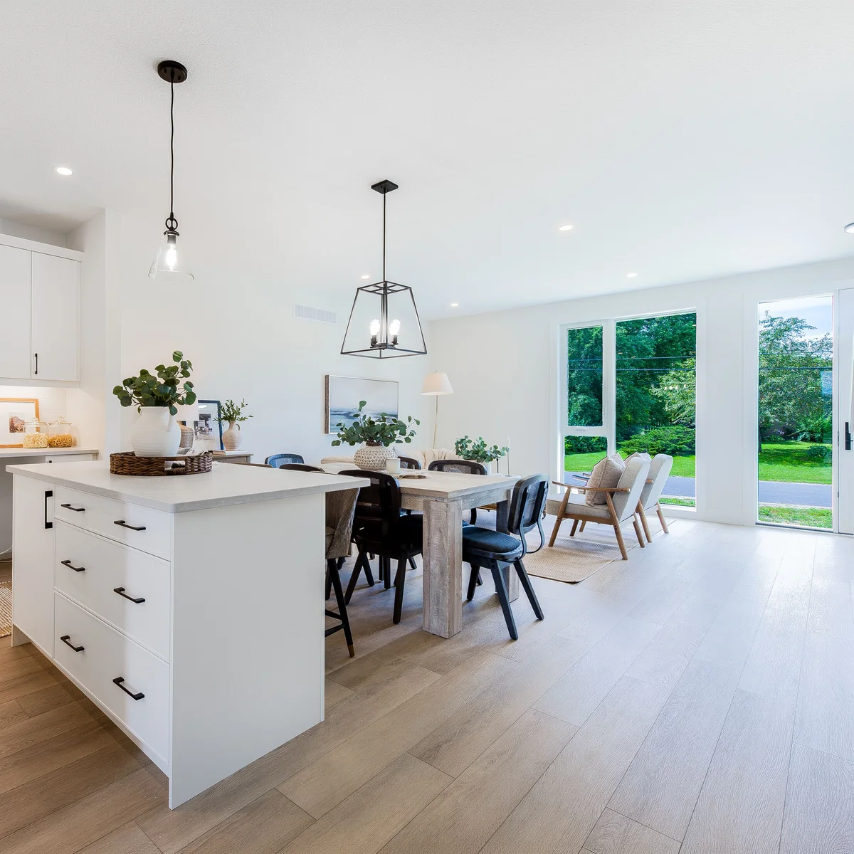 Kitchen and dining area of a Phase 1 townhome with floor-to-ceiling windows onto the green.