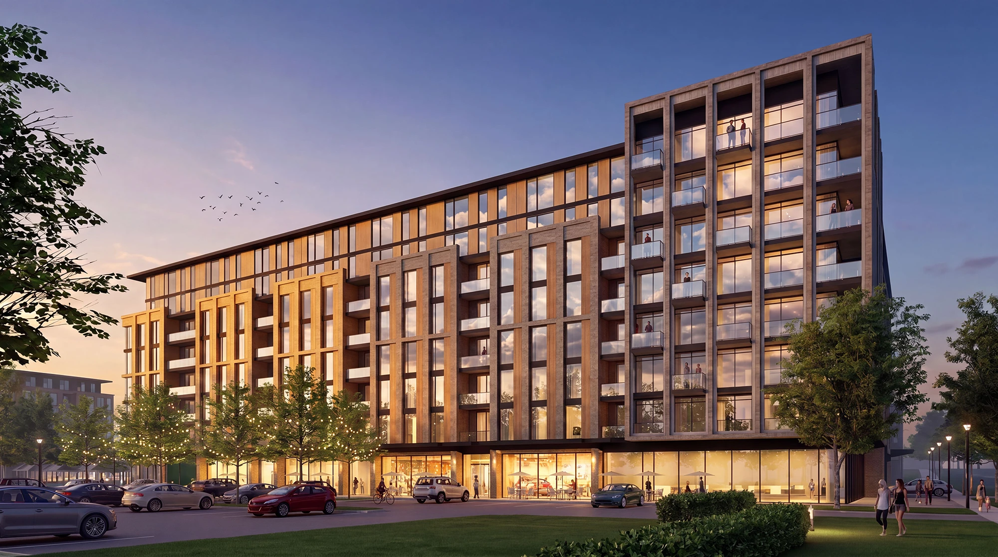Phase 2 corner building at dusk, with ground-floor retail and residential floors above
