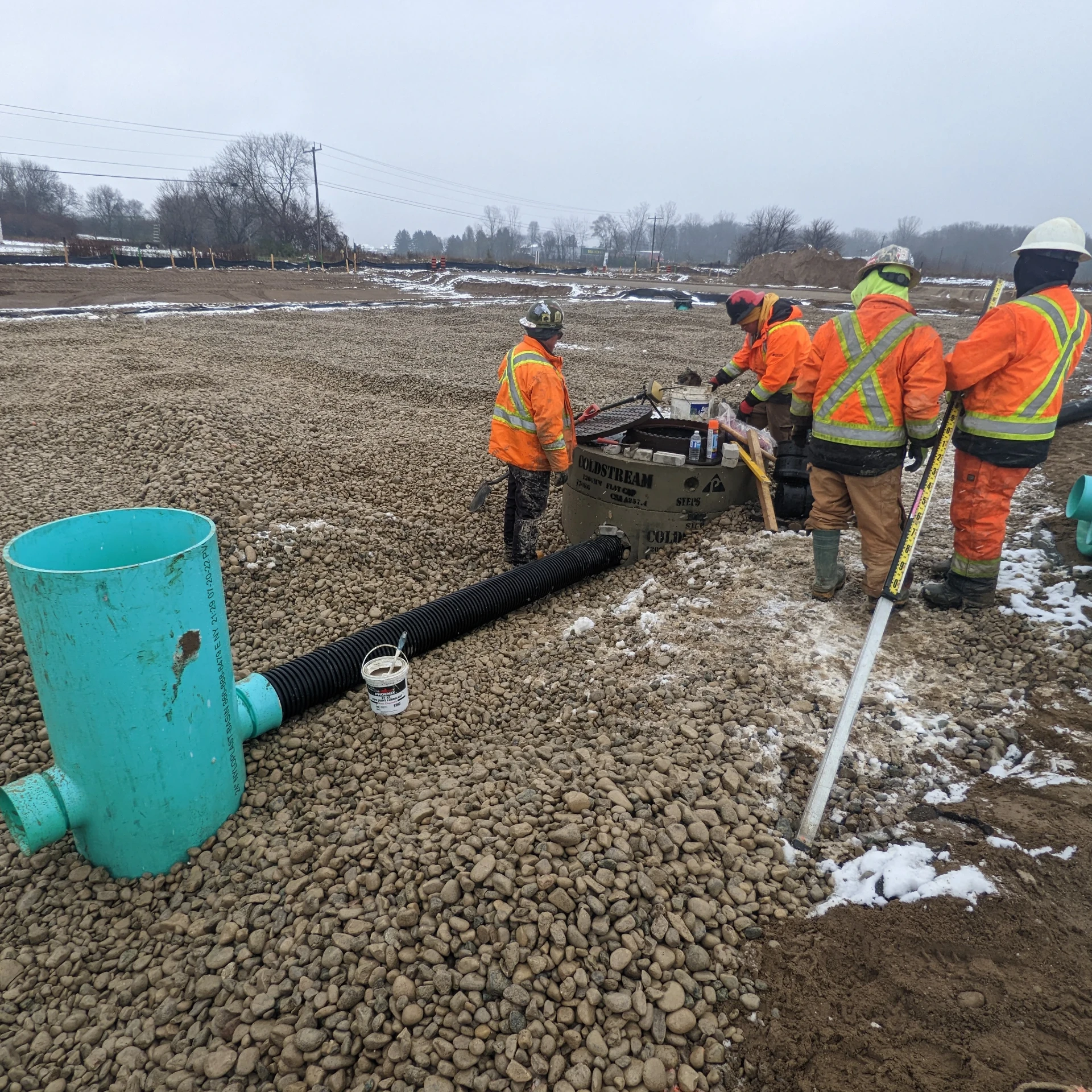 Crews installing a stormwater infiltration gallery in a gravel bed on the Unity Square site.